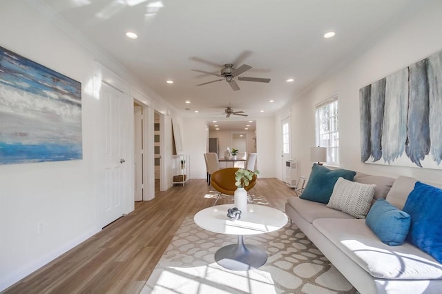 living room with baseboards, ceiling fan, wood finished floors, and recessed lighting