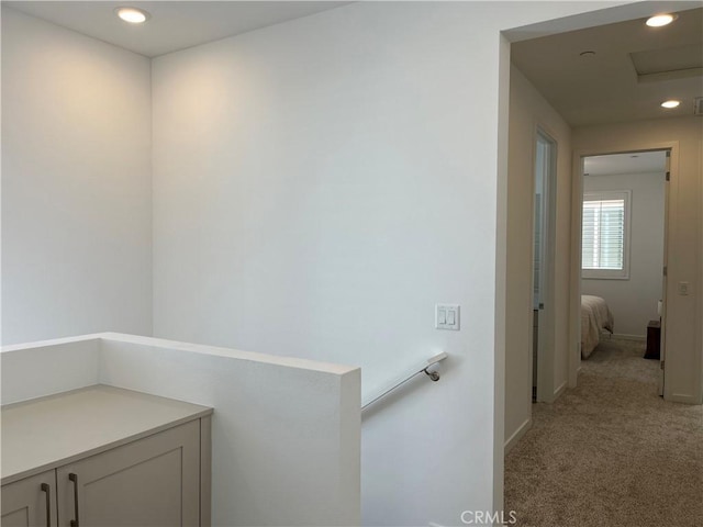 hallway featuring recessed lighting, light carpet, an upstairs landing, baseboards, and attic access