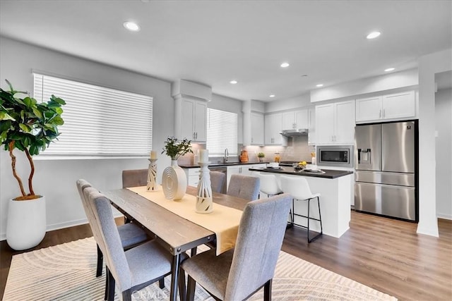 dining area featuring dark wood-style floors and recessed lighting