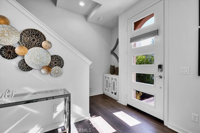 foyer entrance featuring dark wood finished floors and baseboards