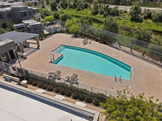 community pool featuring a pergola, fence, and a patio