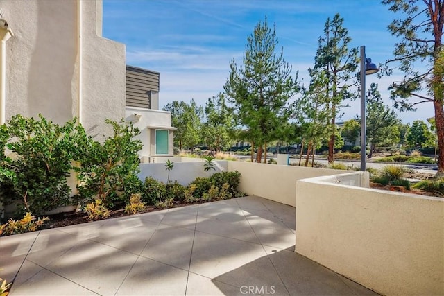 view of patio featuring a balcony