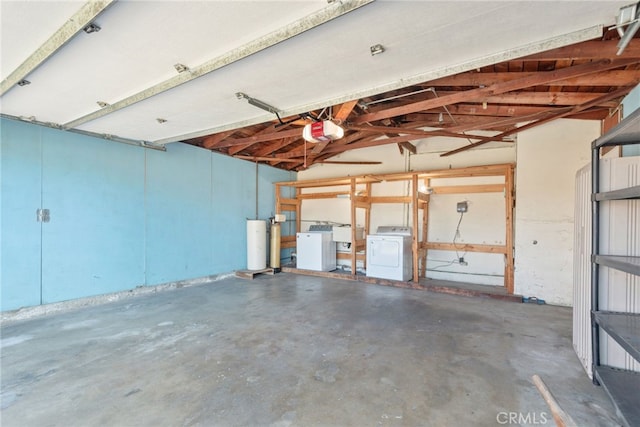 garage featuring washer and dryer and a garage door opener