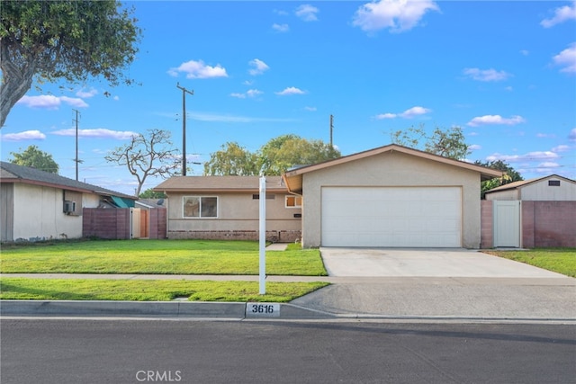 ranch-style house featuring driveway, a garage, stucco siding, fence, and a front yard