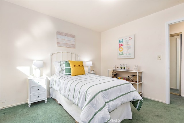 carpeted bedroom featuring baseboards