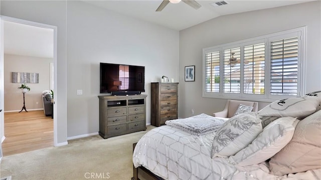 bedroom with baseboards, vaulted ceiling, a ceiling fan, and light colored carpet