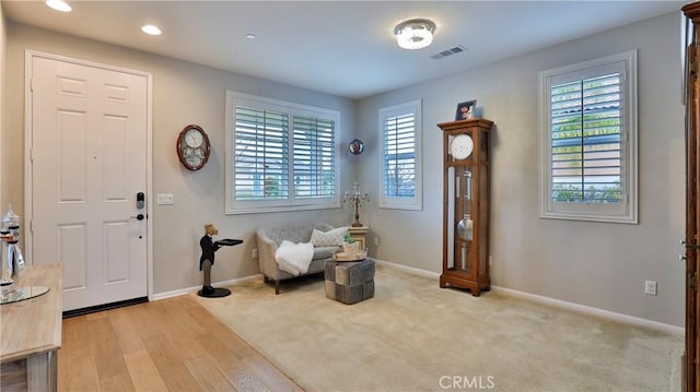 entryway featuring light carpet, baseboards, visible vents, and recessed lighting