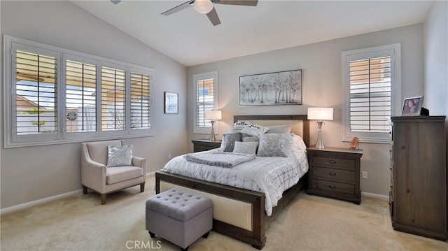 bedroom featuring lofted ceiling, multiple windows, baseboards, and light colored carpet