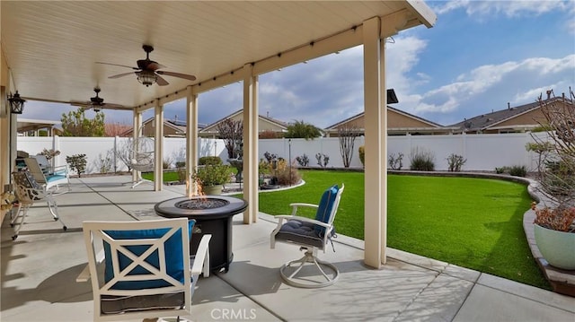 view of patio featuring an outdoor fire pit and a fenced backyard