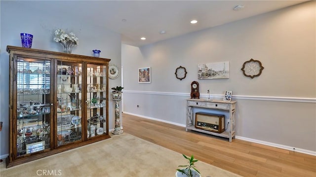 interior space featuring light wood finished floors, baseboards, and recessed lighting