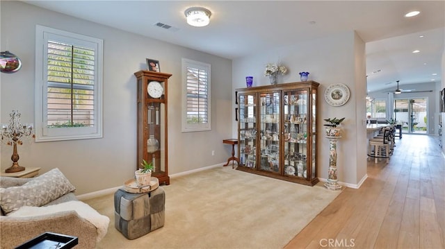 sitting room featuring light wood finished floors, recessed lighting, visible vents, and baseboards