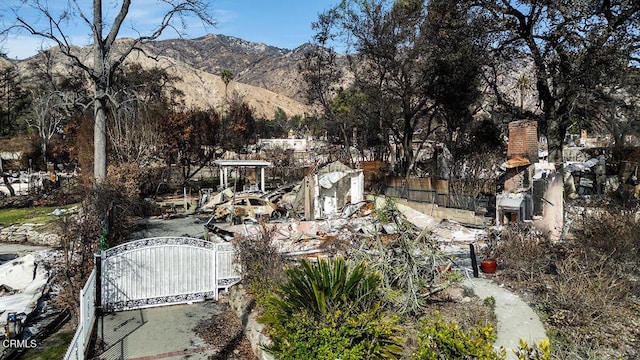 view of yard with a gate, a mountain view, and fence