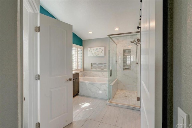 full bathroom featuring lofted ceiling, tile patterned flooring, a marble finish shower, and a bath