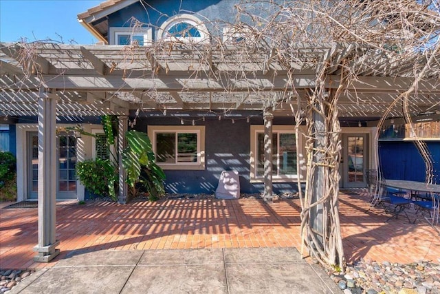 view of front of property with stucco siding and a pergola