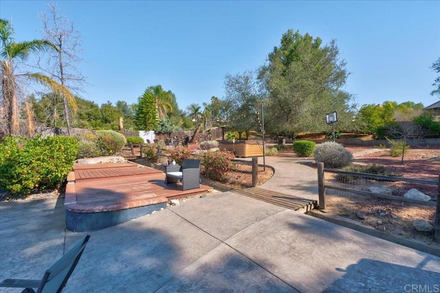 view of patio with fence and a wooden deck