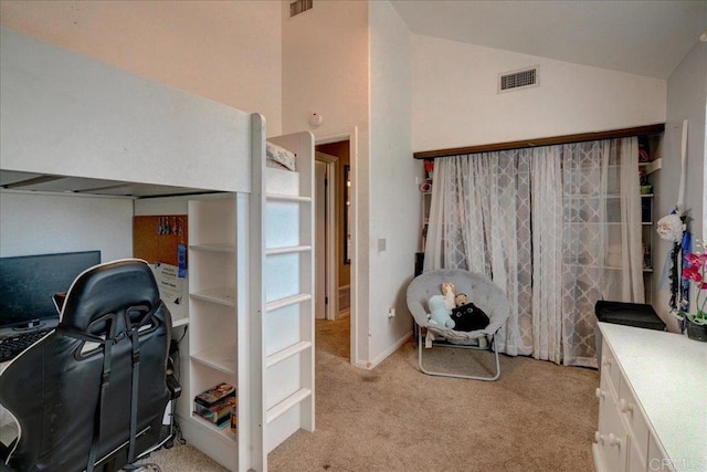 interior space featuring light colored carpet, visible vents, and vaulted ceiling