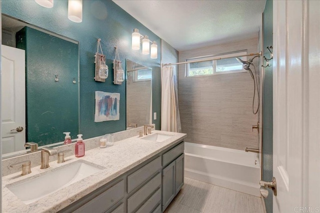 bathroom featuring shower / tub combo, a sink, and double vanity