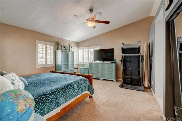 bedroom featuring a ceiling fan, carpet, vaulted ceiling, and baseboards