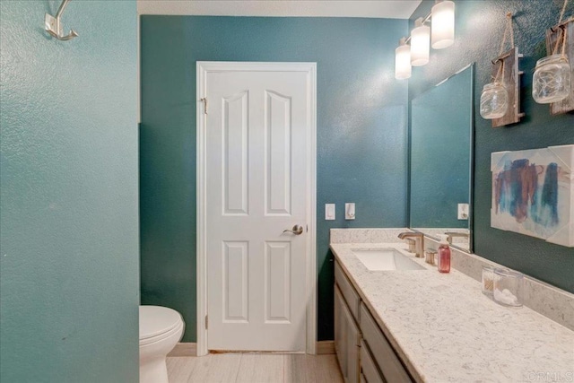 bathroom featuring toilet and vanity