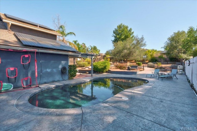 pool featuring a patio area and fence