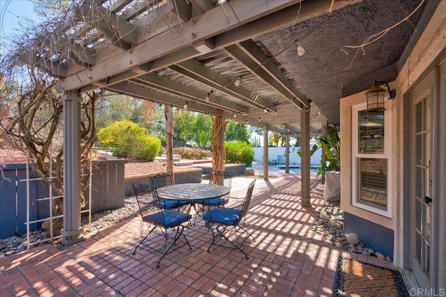 view of patio / terrace with outdoor dining area, fence, and a pergola