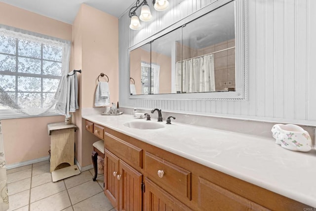 bathroom featuring baseboards, a shower with shower curtain, vanity, and tile patterned floors