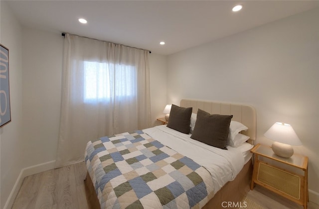 bedroom featuring recessed lighting, wood finished floors, and baseboards