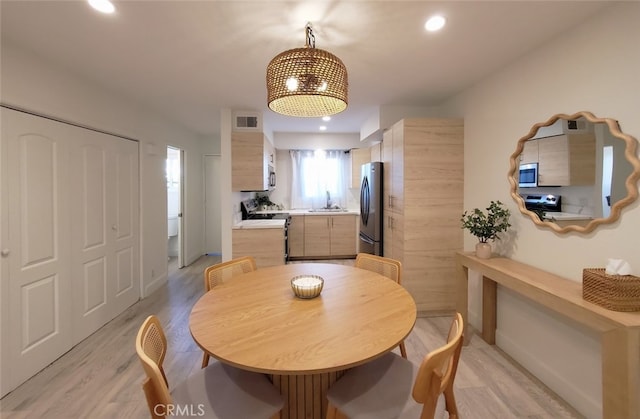 dining area with recessed lighting, visible vents, baseboards, and light wood finished floors