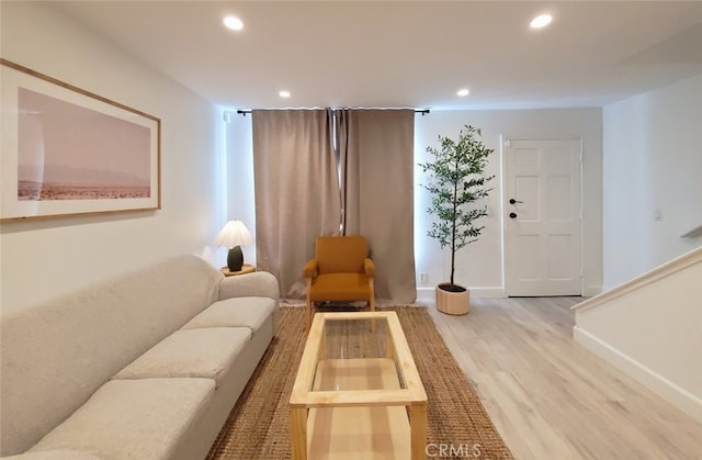 living area with recessed lighting, wood finished floors, and baseboards