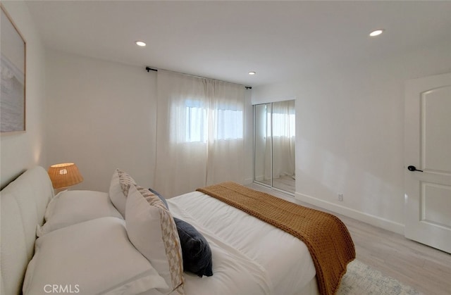 bedroom featuring recessed lighting, baseboards, and light wood finished floors