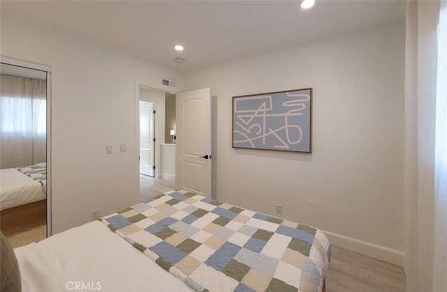 bedroom with recessed lighting, visible vents, baseboards, and light wood-style flooring