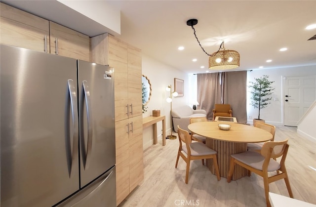 dining space with recessed lighting, light wood-type flooring, and baseboards