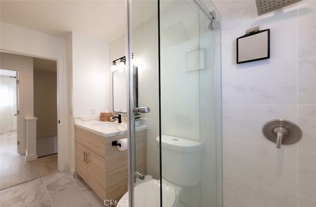 full bath featuring vanity, toilet, marble finish floor, and a tile shower