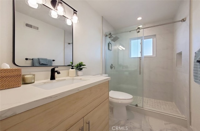 bathroom featuring vanity, visible vents, a shower stall, toilet, and marble finish floor