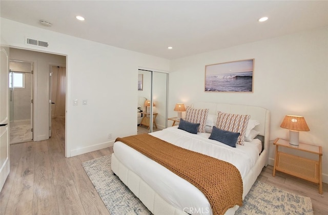 bedroom featuring visible vents, baseboards, light wood-style flooring, recessed lighting, and a closet