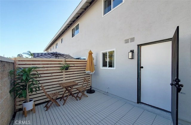 view of patio with visible vents and fence