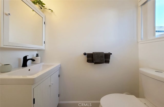 half bathroom with toilet and vanity