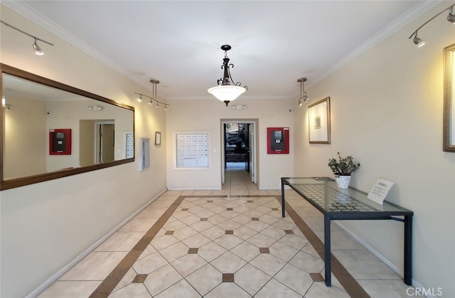 hall with light tile patterned floors and ornamental molding