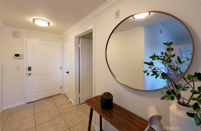 entrance foyer with light tile patterned floors, baseboards, and crown molding
