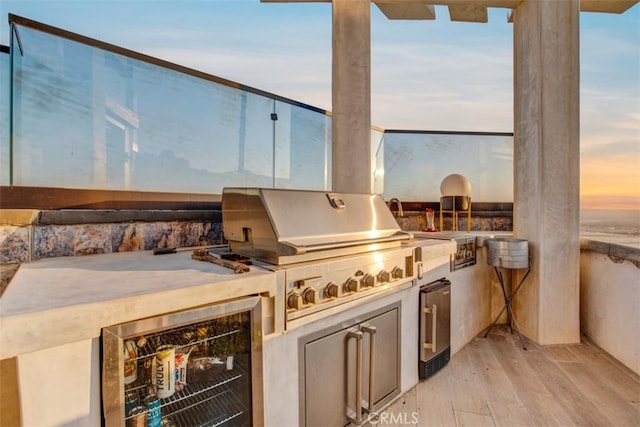 view of patio with a grill, wine cooler, and exterior kitchen