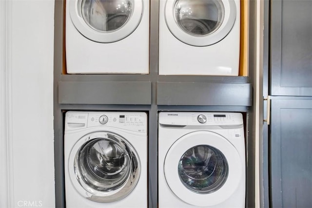 laundry room with stacked washer / dryer