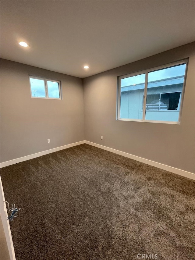 carpeted empty room featuring recessed lighting and baseboards