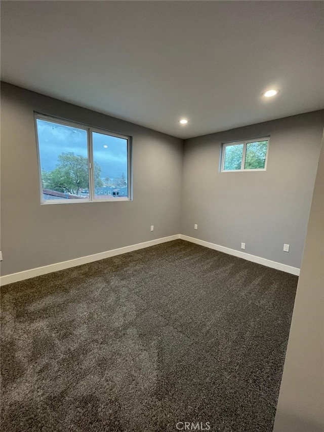 carpeted empty room with recessed lighting and baseboards