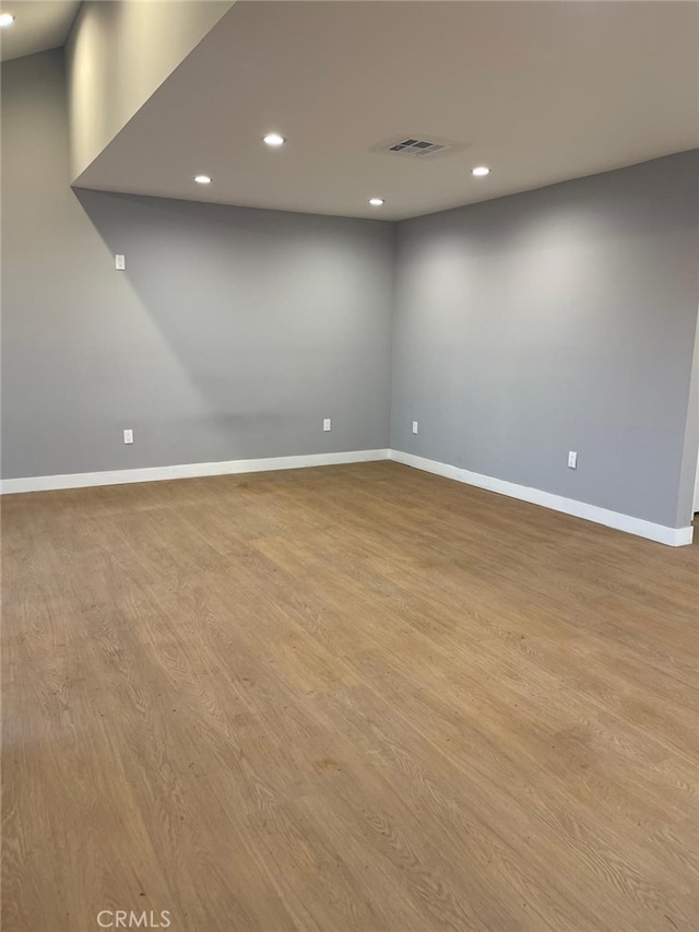 basement with light wood finished floors, recessed lighting, and baseboards