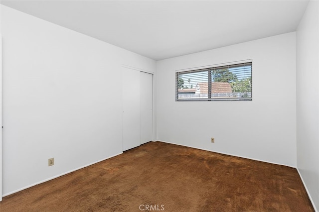 empty room featuring dark colored carpet