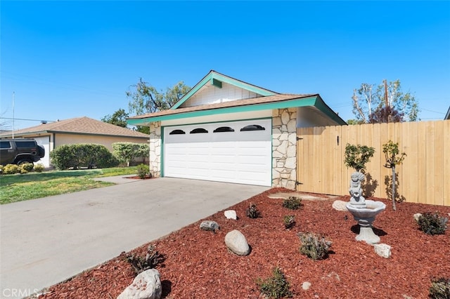 single story home with driveway, stone siding, a garage, and fence