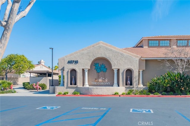 view of building exterior with uncovered parking