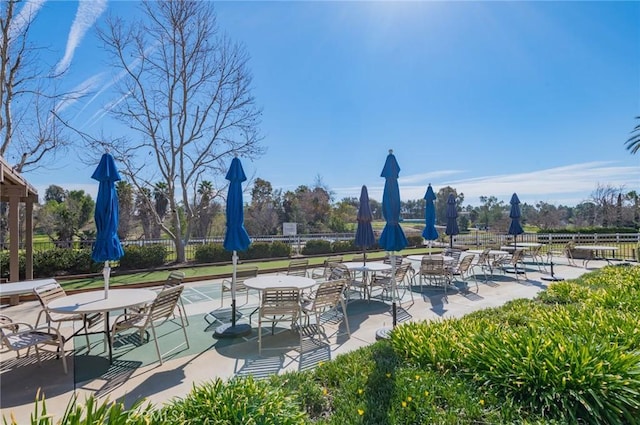 view of home's community with shuffleboard and fence