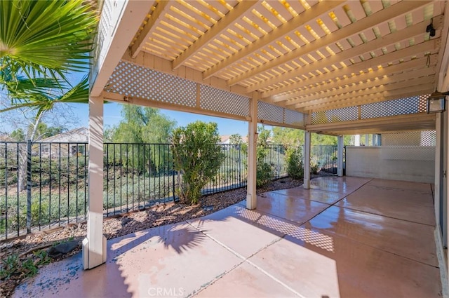 view of patio with a pergola and fence