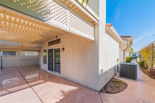 view of patio / terrace with central air condition unit and a pergola